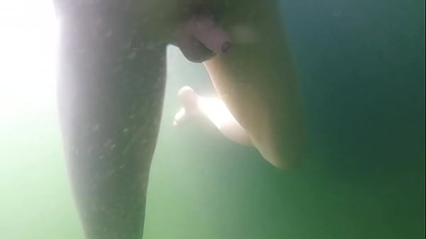 Pierced guy is swimming naked and plays a bit with his tiny shaved cock